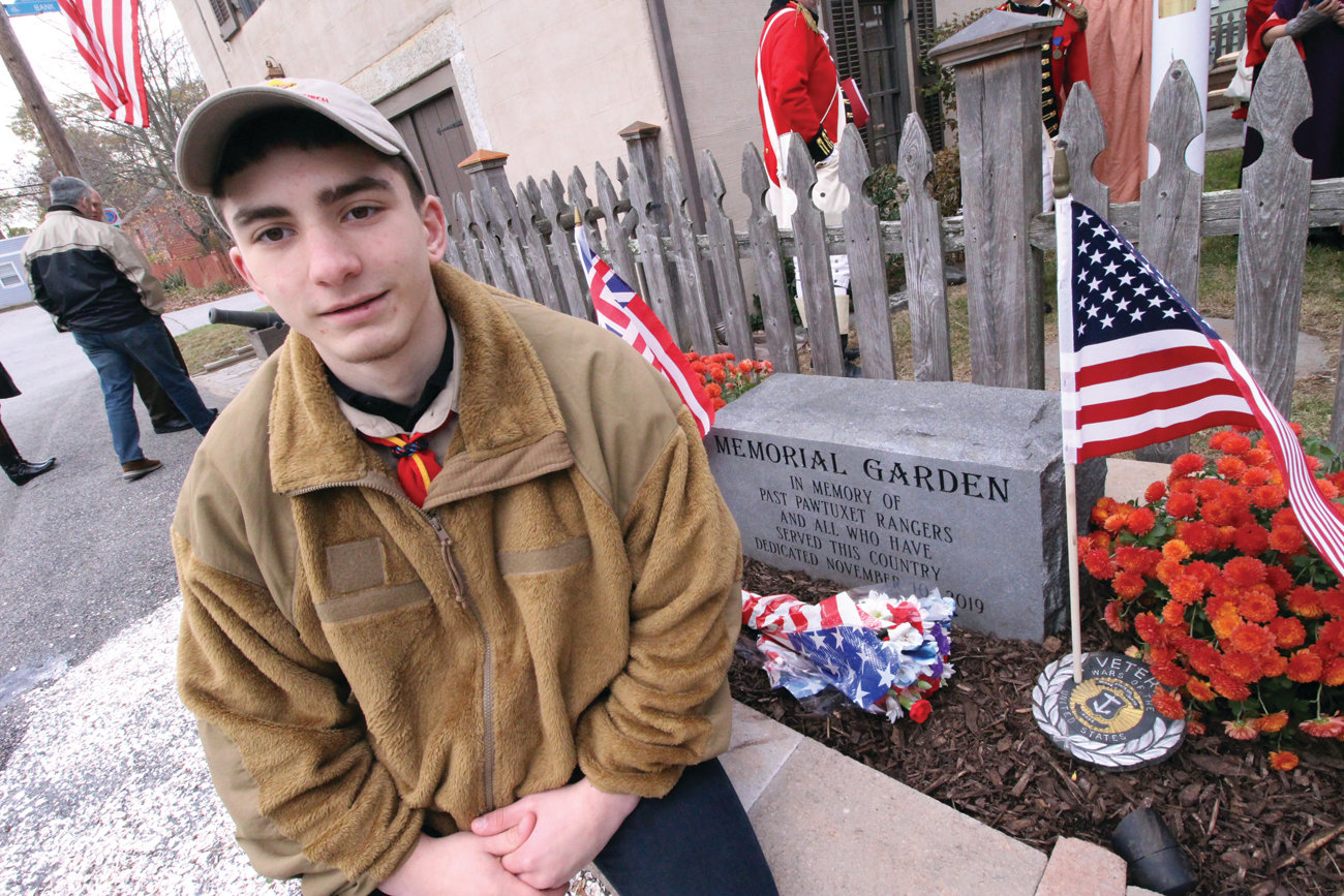 THE GARDEN HE HELPED BUILD: Nicholas Loffler is seen at the memorial that he and members of Providence Troop 76 built at the Pawtuxet Rangers Armory.
